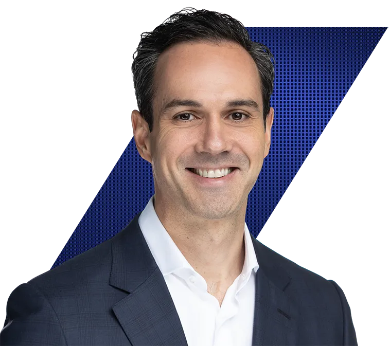 Headshot of a Steven White of Vista Equity Partners, wearing a dark blue suit jacket and white shirt, against a black and blue geometric background.