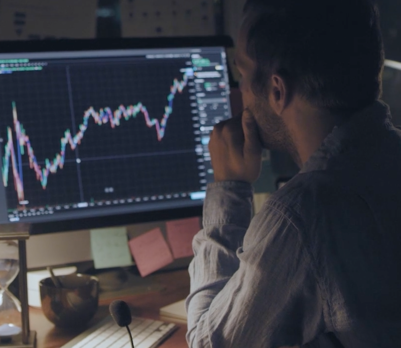 Image of man reviewing financial data on a computer