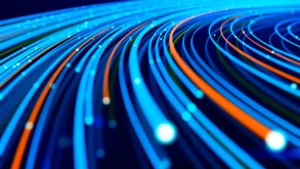 Abstract image of glowing blue and orange curved lines with bright light particles, representing data flow or fiber optics.