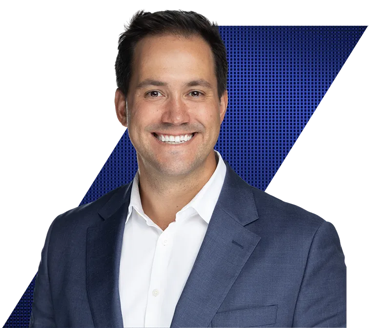Headshot of a smiling man in a blue suit jacket and white shirt against a black and blue geometric background.