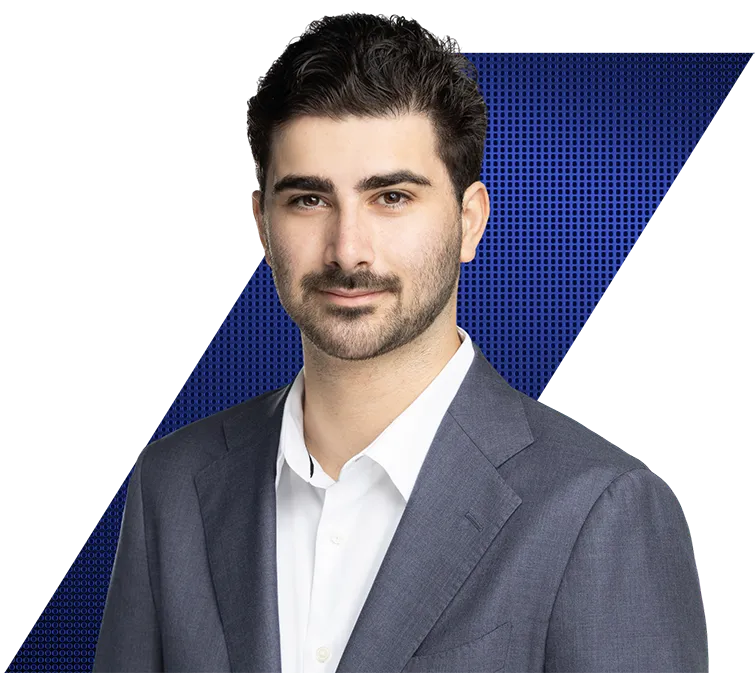 Headshot of a man with dark hair and a beard, wearing a suit jacket and white shirt, against a black background with blue geometric patterns.