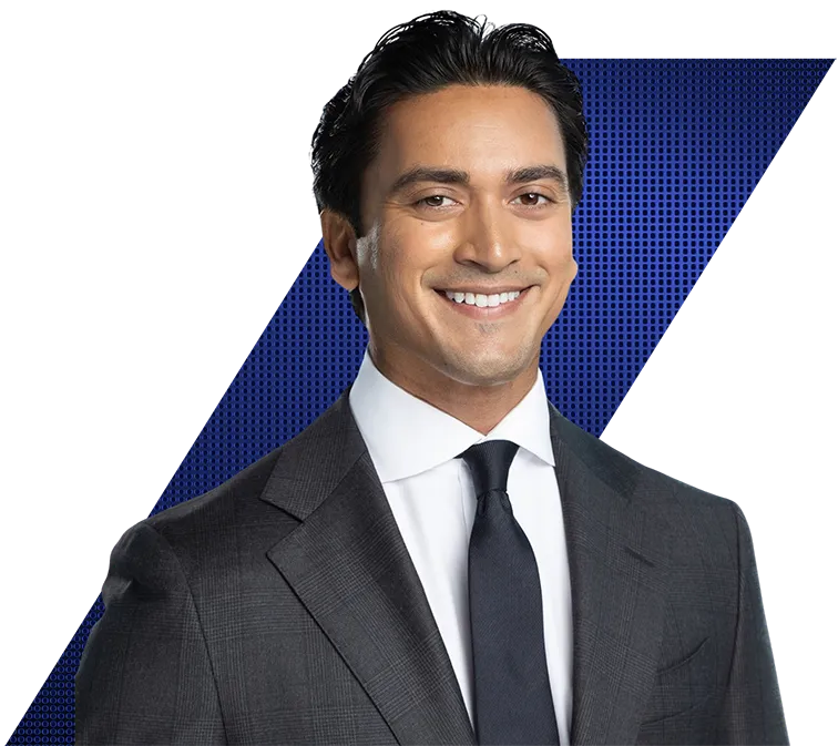 Headshot of a smiling man in a dark gray suit, white shirt, and navy tie, against a black and blue geometric background.