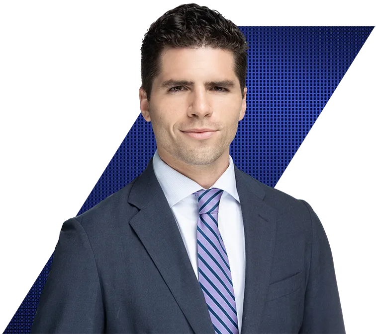 Headshot of a smiling man in a dark suit, white shirt, and striped tie against a black and blue patterned background.